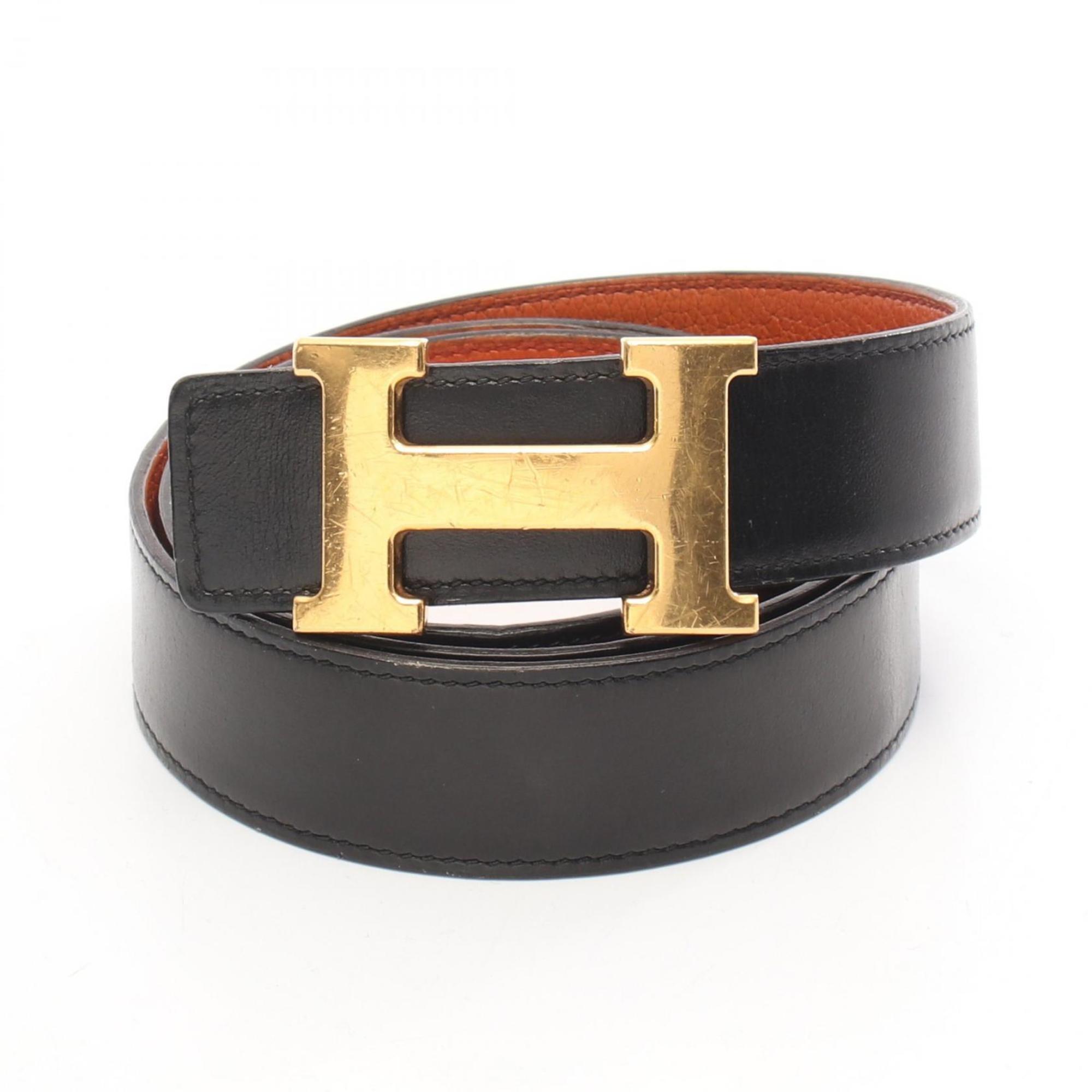 Hermes HermÃ¨s Constance H Belt, men’s calfskin Togo box calf leather belt in black and orange.